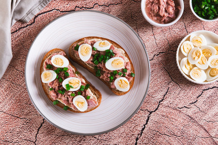 Delicious sandwiches on grain bread with egg on a plate on the table top view