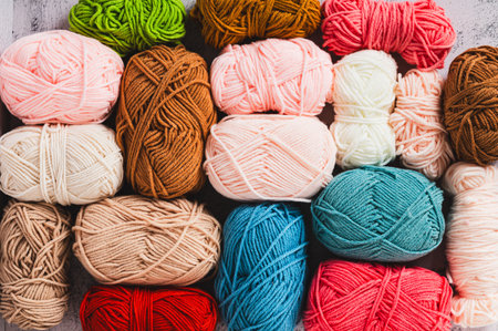 Solid color textured background made of skeins of yarn for handicrafts, top view