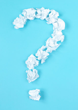 Question mark symbol arranged by crumpled ball paper on blue background. concept of finding an idea and solving a problem.の写真素材