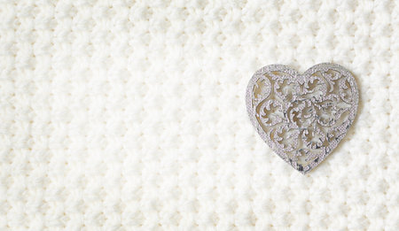 wooden heart symbol of love on white fur background, Saint Valentine Day concept.の写真素材