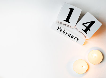 Valentines Day background with candles and wooden block calendar february 14.の写真素材