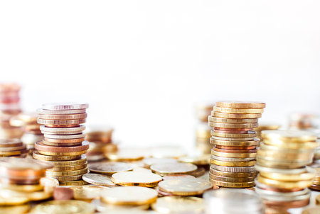 stacks of gold coins on a white backgroundの写真素材