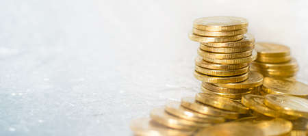 Background golden pile of different gold coins on the table.