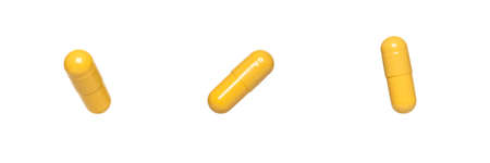 three yellow capsules or pills isolated on white background.