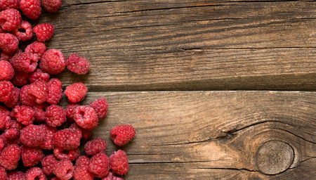 fresh pile of raspberries on a wooden background.の写真素材