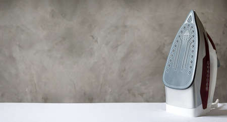 the iron is on the ironing board. banner with copy space.の写真素材