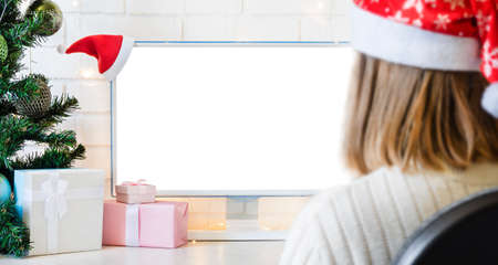 monitor with white screen with copy space and gifts and blurry silhouette of the girl.の写真素材