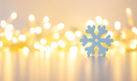 wooden snowflake close up on a golden background with bokeh.の写真素材