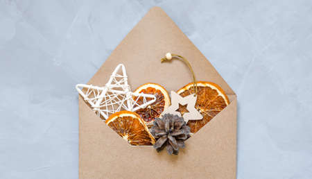 dried oranges, Christmas toys and a cone in a craft envelope.の写真素材