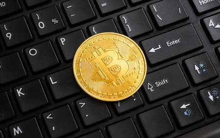 Bitcoin golden coin on black computer keyboardの写真素材