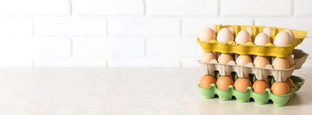 fresh chicken eggs in different trays on the table. banner with copy spaceの写真素材