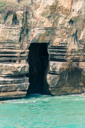 Cave on the rocks of the seaの写真素材