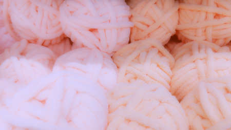 Defocused background of soft balls of wool in pink colors. The concept of coziness and comfort.の写真素材