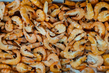 Freshly frozen shrimp and metal tray for collecting close-up. Seafood for food.の写真素材