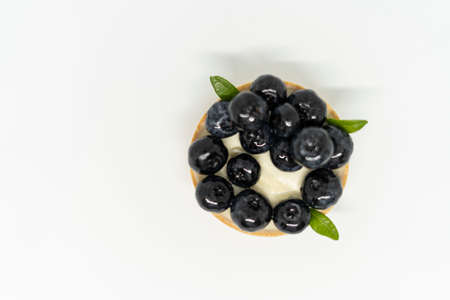 Top view of a tartlet with blueberries on a white backgroundの写真素材