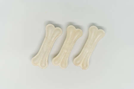 Artificial bone for a dog with vitamins on a white background, three piecesの写真素材