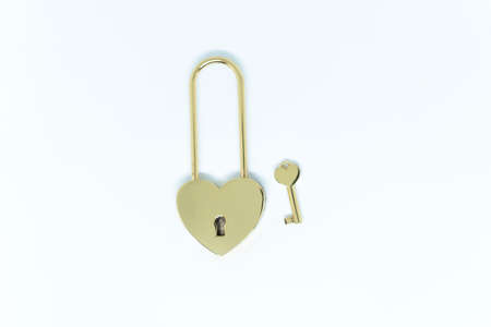 A heart-shaped padlock with a key on a white background. Copy spaceの写真素材
