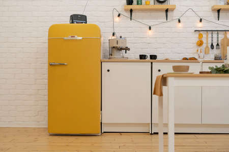 Part of the kitchen with yellow refrigerator, retro style