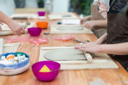 Close-up of a child making handmade ceramics in a ceramics classroom, copy spaceの写真素材