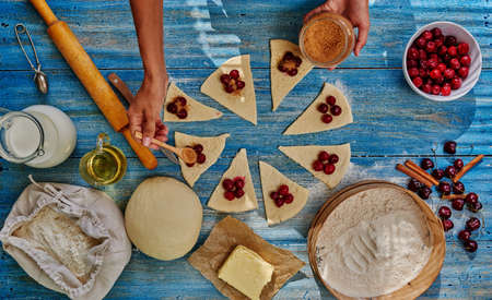 She lays cherry filling over the dough sprinkles brown sugar, it will be gentle bagelsの写真素材