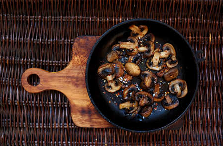 Fresh mushrooms collected in the forest fried in a deep frying pan,mushroom protein source,space for textの写真素材