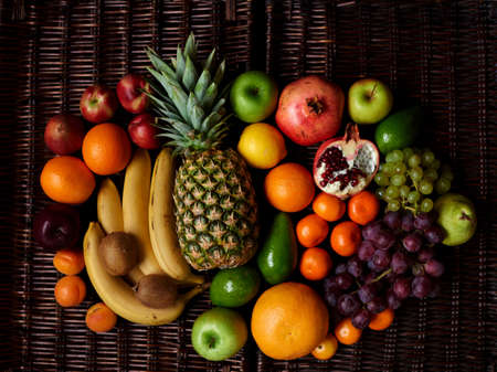 There are fruits on the rattan tableの写真素材