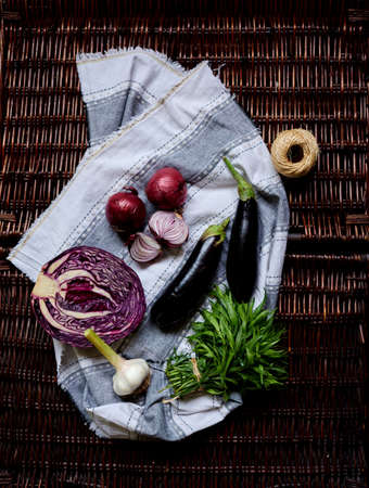 Fresh washed vegetables laid out on a gray linen kitchen towelの写真素材