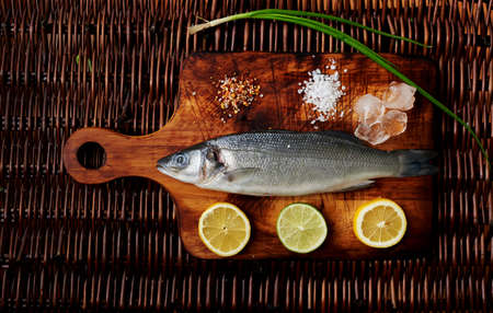 Cook unfrozen fresh sea bass to cook it on the grill. Small seabass excellent dinner useful in large fish kolichesvo useful microelementsの写真素材