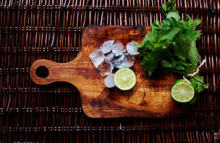 Mint ice and lemon on the rattan table, ingredients of barkeeper  to create a cocktail mojito, summer coctailの写真素材