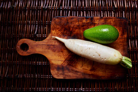 Horseradish and avocado on the vintage table, creative picture of fresh veggiesの写真素材