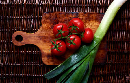 Freshly picked from the garden vegetables are on the cutting board and ready for further preparationの写真素材