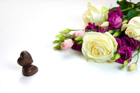 chocolate hearts and white and purple roses for Valentine's day holiday on white backgroundの写真素材