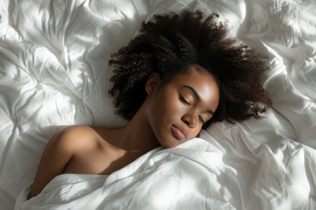 female sleeping in white bedの素材