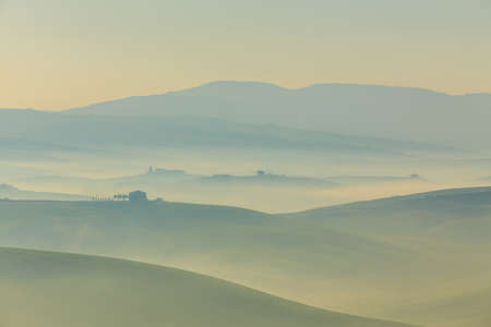 Misty sunrise in Tuscany, central Italy, which extends from the hills south of Siena to Monte Amiata.の写真素材
