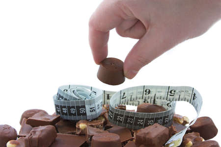 Woman stealing a chocolate from the plate.の写真素材