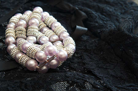 Purple pearl bracelet on black lace lingerie.の写真素材