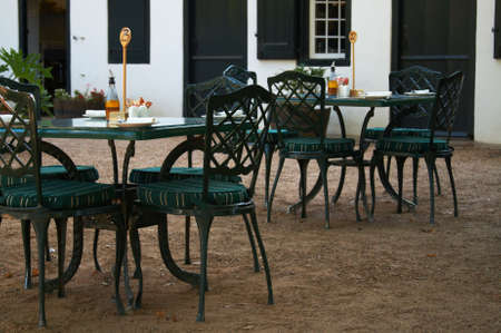 Garden coffee-shop with metal tables and chairs on a warm summer day.の写真素材