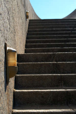 Stairs leading to Afrikaans Language Monument shot on blue sky background in Paarl, Western Cape, South Africa. One of the lights on the wall is in focus.の写真素材