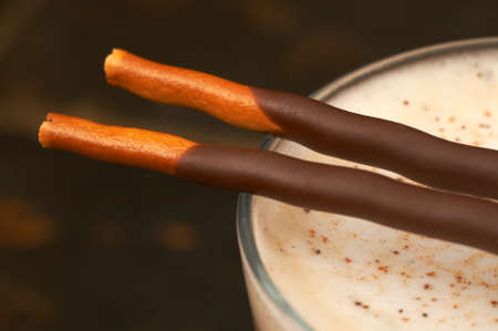 Closeup of caffe latte with chocolate sticks. Shot with a macro lens, the stick is in focusの写真素材