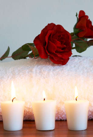 Relaxing spa scene with nourishing and exfoliating body scrub, brush massager and candles in the backgroundの写真素材