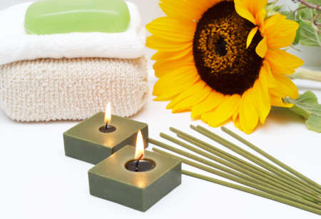 Relaxing spa scene with candles, incense sticks, body sponge, face towel and handmade glycerin soapの写真素材