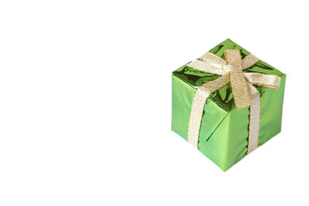 Green mini gift box with gold ribbon isolated on white background with copy spaceの写真素材