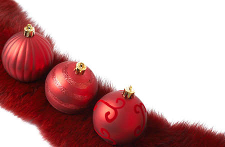 Three red Christmas baubles on luxurious fur isolated on white background with copy space. Shallow depth of fieldの写真素材