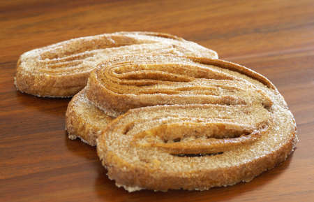 Macro shot of palmier cookies on wooden table background, very shallow depth of fieldの写真素材