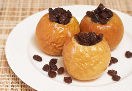 Delicious dessert of freshly baked organic apples with raisinsの写真素材