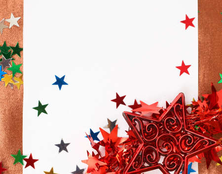 White Christmas card with stars and bows decorations on golden silk backgroundの写真素材