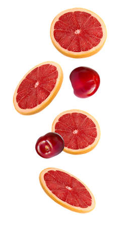 Slices of pink grapefruit and cherry in the fall isolated on white background. A set of fruits and berries.の写真素材