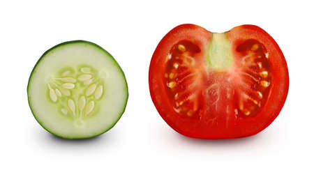 Slice of cucumber and half a tomato isolated on white background. Summer vegetables. Vegetables for packaging design for cosmetics, organic farm products, preservation, detox drinks, juices.の写真素材