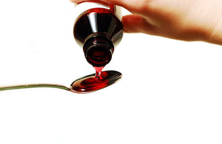 Cough syrup poured into a spoonの写真素材