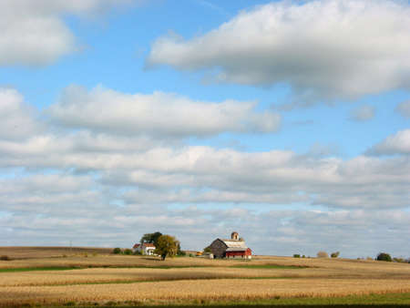 Farm house, barn and fields under blue skyの写真素材